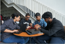 Students interacting with research and development equipment at T-Works